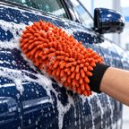 AI-assisted illustrative view of the orange chenille wash mitt gently washing a car side panel