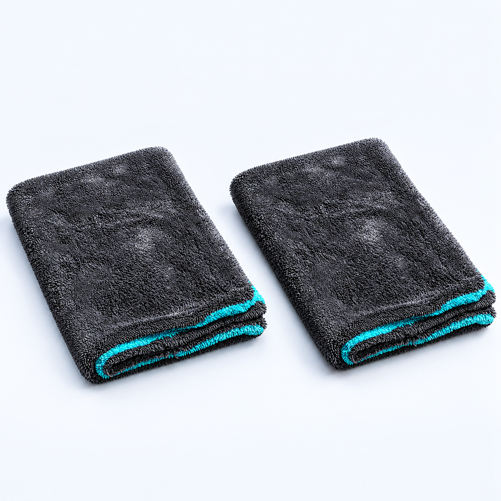 AI-assisted product composition showing exactly two grey and turquoise Hydrolock drying towels